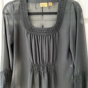 Black sheer blouse with detailed ribbon on neckline and sleeves